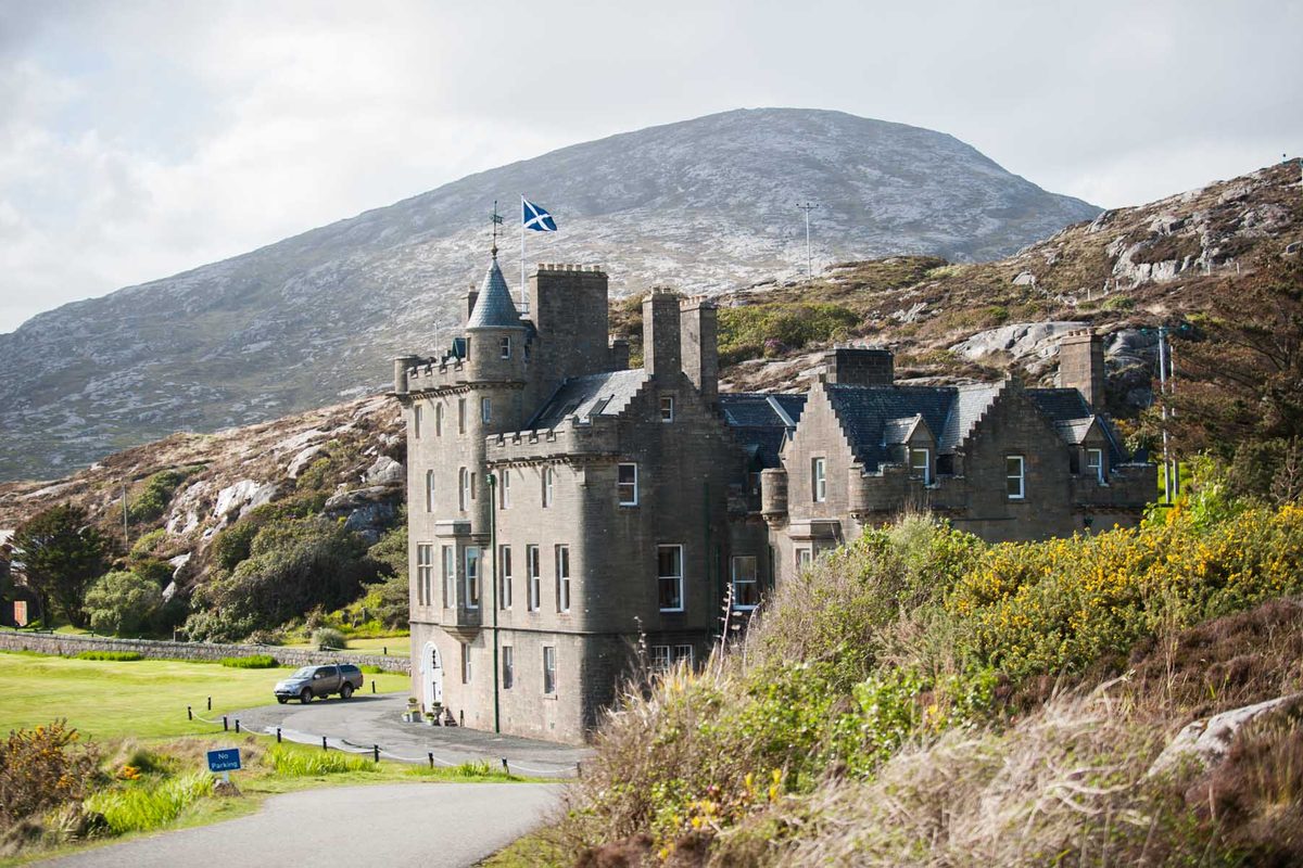 Amhuinnsuidhe Castle with the hills of North Harris rising behind