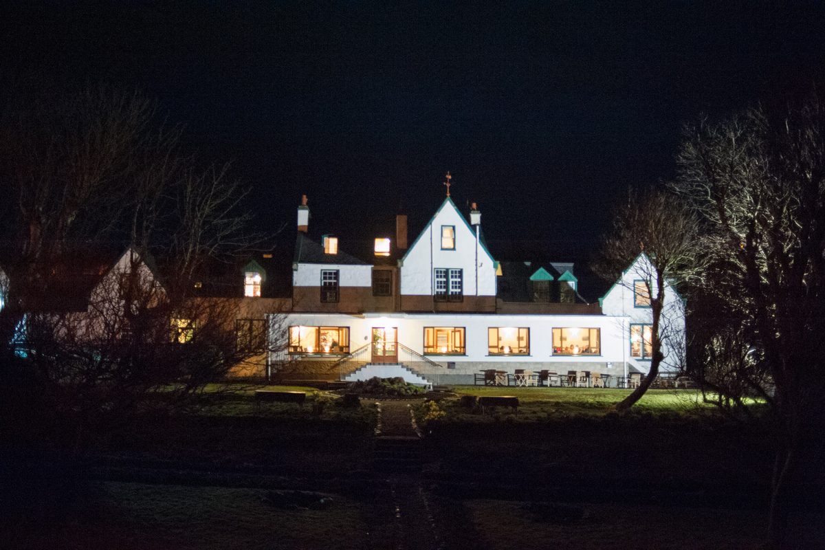 The Harris Hotel lit up at night in Tarbert, Isle of Harris