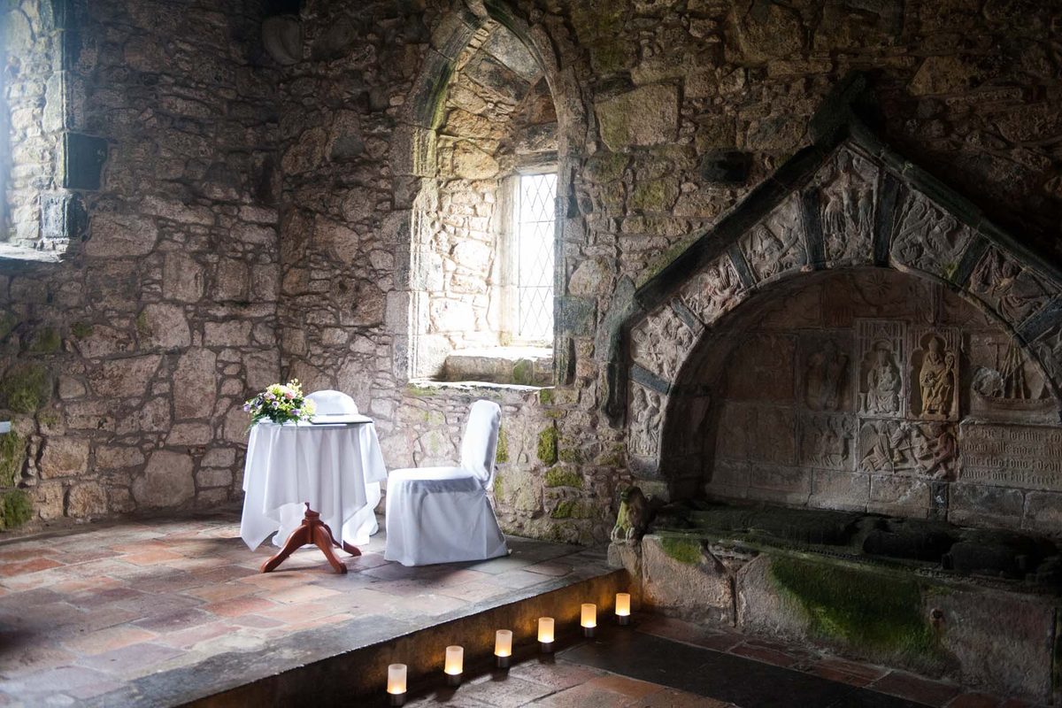 Candlelit ceremony table inside St Clement's Church, Rodel, Isle of Harris
